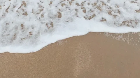 Sea surf on beach, top view, white foam, close-up Stock Footage 243986469