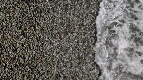 Sea surf close-up on pebble beach at day Video stock 264092314