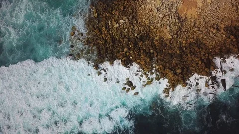 Sea surf footage from above. Cliffs and the ocean. Aerial drone shooting. Stock Footage 100712682