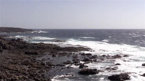 Sea surf on the rocks in the area  Punta Pesebre  on Fuerteventura Stock Footage 54199296