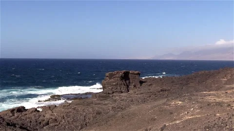 Sea surf on the rocks in the area  Punta Pesebre  on Fuerteventura Stock Footage 54230700