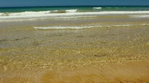 Sea, surf, sand, waves lapping on the shore. 動画素材 64035050