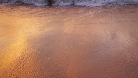 Sea surf on a sandy beach during a colorful sunset. Stock Footage 120416940