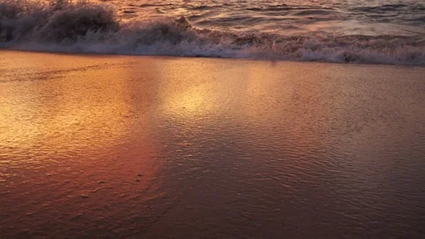 Sea surf on a sandy beach during a colorful sunset. Stock Footage 120518211