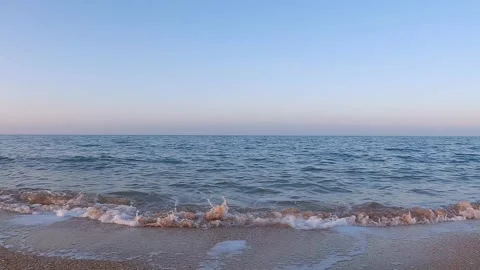Sea surf on a sandy beach at sunset Stock Footage 249587236