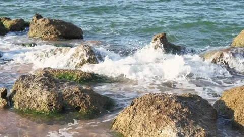 Sea surf splashed among stones on coast Stock Footage 330429607