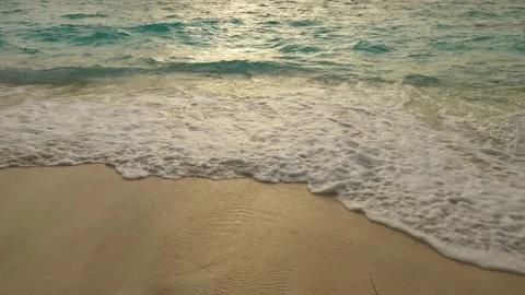 Sea surf at sunset on the sandy beach of a tropical island Stock-Footage 230971504