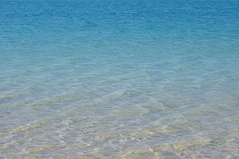 Sea surface. Aqua blue color water texture. Copy space, top view. Stock Photos