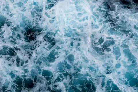 Sea surface background with splashing waves. Top view. Stock Photos