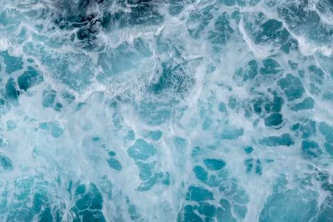 Sea surface background with splashing waves. Top view. Stock Photos