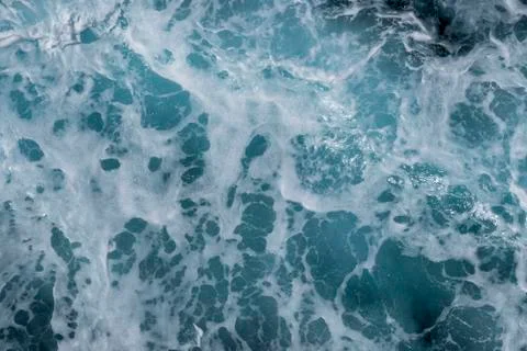Sea surface background with splashing waves. Top view. Stock Photos