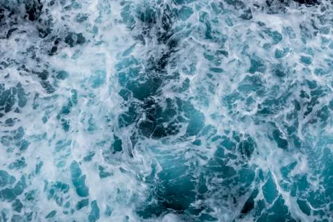Sea surface background with splashing waves. Top view. Stock Photos