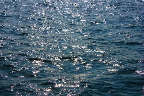 Sea surface. Background texture of a calm deep blue ocean with ripples on the Stock Photos