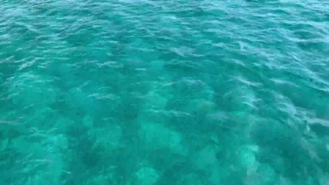 Sea surface background turquoise Too many shiny reflections of the sun in the wa Stock Footage 220615973