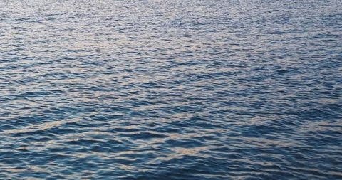 Sea surface reflection sunrise close up shot. Beautiful summer blue sea waves Stock Footage 111959849