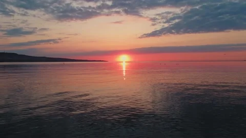 Sea surface with small waves against backdrop of sunset of sun evening Video stock 136161720