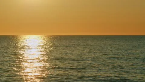 Sea Surface Small Waves View Against Of Golden Sun. Big Red Hot Sun In Warm Air Stock Photos