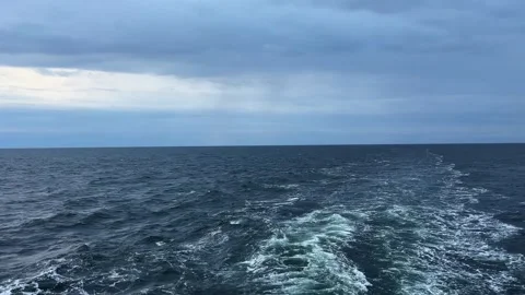 Sea surface with wake from ship at overcast windy morning Stock Footage 345663798