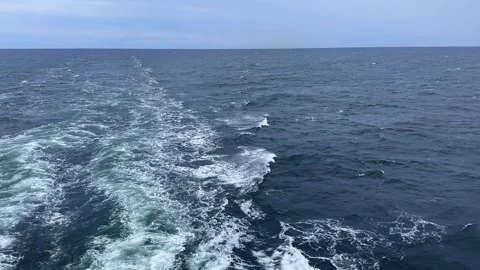 Sea surface with wake from ship at overcast windy morning Stock Footage 345663904
