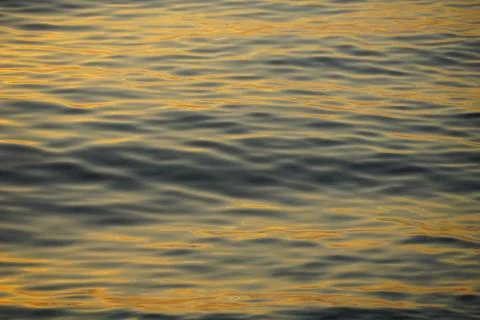 Sea surface with yellow reflection of the sun rays on the surface of the se.. Stock Photos