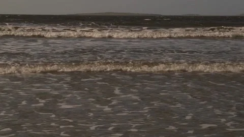 Sea tide fast approaching beach. Ireland. 動画素材 201525732