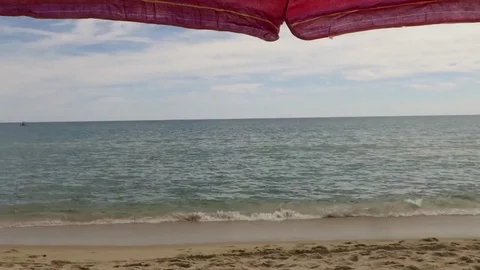By the sea under the umbrella Stock Footage 80486355