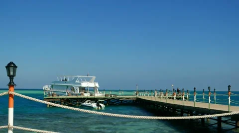 Sea vacation, tourism, Red Sea, Egypt. Tourist vacationer on pier with ship boat Stock Footage 59676905