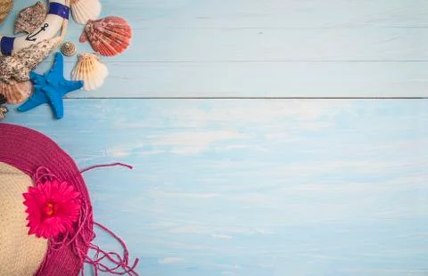 Sea vacations background. Various seashelles, starfish and beach hat on blue  Stock-Fotos