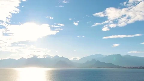 Sea View And Sky Timelapse. Sea view at sun rays on the mountains background. Stock Footage 84815529