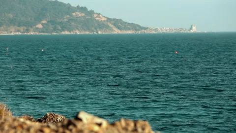 Sea view from behind a small stone. Stock Footage 252278975