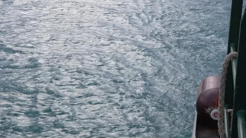 Sea view from the board of a floating boat. View back. Motion sea wave Stock Footage 129888251