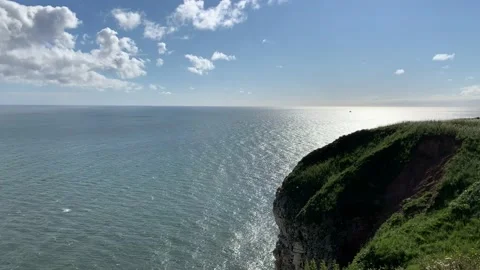 Sea view with calm waves and a large rock face Stock Footage 136586485