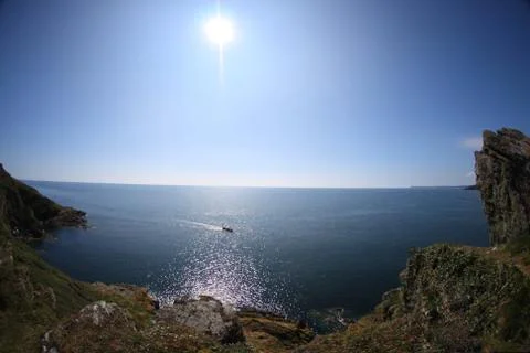 Sea view from cliffs, blue sky and sun, Cornwall, England Stock Photos