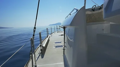 Sea view from the deck of a sailing catamaran on a sunny day. Slow motion. Stock Footage 103577580