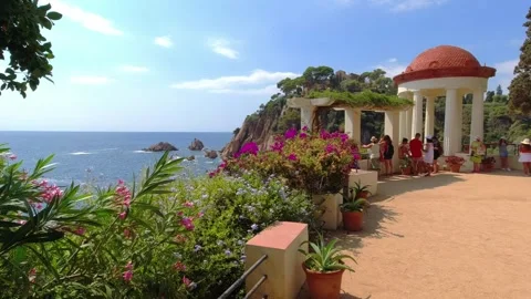 Sea view with flowers and decorative terrace in Jardí Botànic Marimurtra Stock Footage 250354493
