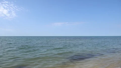 Sea view on the nice summer day: blue sky with small clouds, clean blue water. Stock Footage 114317291