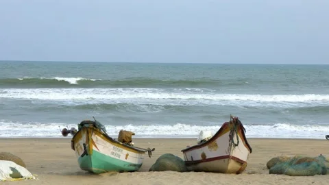 Sea view with waves crashing with two boats on shore Stock Footage 172494789