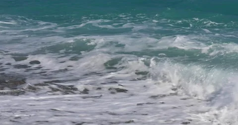 Sea view. Waves run over the rocky pebble beach Stock Footage 153792099