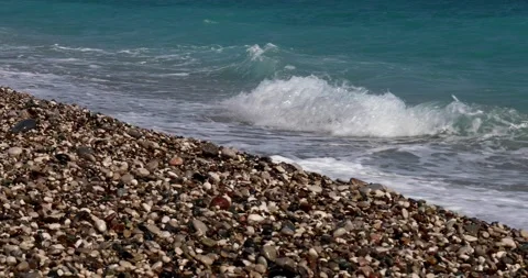 Sea view. Waves run over the rocky pebble beach Stock Footage 153792132