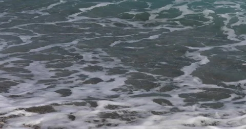 Sea view. Waves run over the rocky pebble beach Stock Footage 153792159