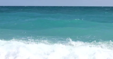 Sea view. Waves run over the rocky pebble beach Stock Footage 153792222