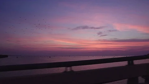 Sea view while the sun is rising on the bridge Stock Footage