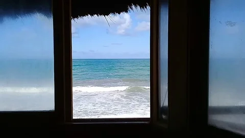 Sea view at window with unrecognizable surfer Stock Footage 108455044