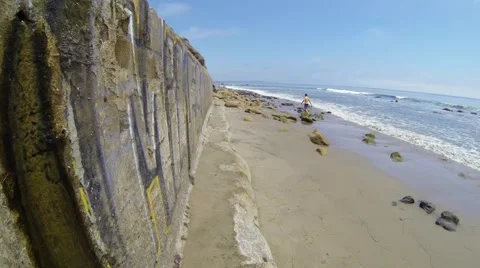 Sea wall with man walking Stock Footage 40450284