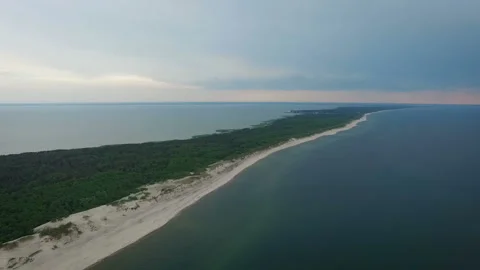 The sea is washed by the borders of the peninsula with a sandy beach. Green Stock-Footage 93799561