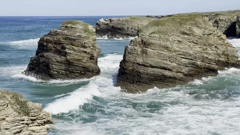 Sea water during the surf, waves crashing against coastal rocks Stock Footage 332130955