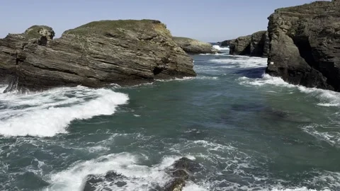 Sea water during the surf, waves crashing against coastal rocks Stock Footage 332130961