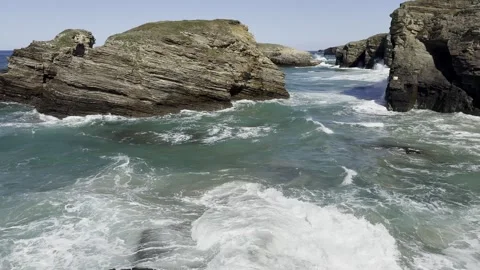 Sea water during the surf, waves crashing against coastal rocks, Lanzada be.. Stock Footage 332343904