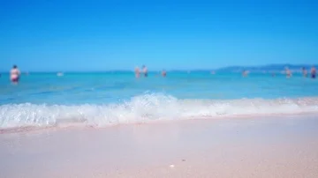 Sea water splashes in camera close up. Low angle shot people walking and swiming Stock Footage 86154971
