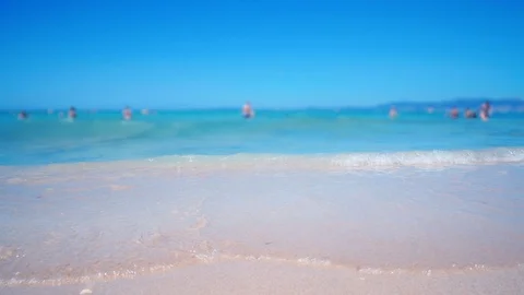 Sea water splashes in camera close up. Low angle shot people walking and swiming Stock Footage 86155647